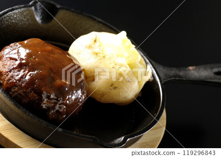 Hamburg steak and buttered potatoes photographed against a black background 119296843