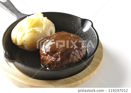 Hamburg steak and buttered potatoes photographed on a white background Hamburg steak and buttered potatoes photographed on a white background 119297012