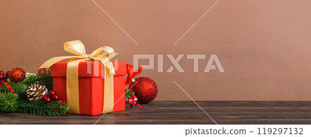 New Year Christmas mood, gift box, branches of a christmas tree, New Year decorations on a colored background New Year Christmas mood, gift box, branches of a christmas tree, New Year decorations on a colored background 119297132