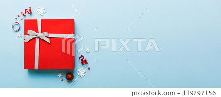 Top view Flat lay Christmas decorations and gift box on colored background with copy space. Christmas or Happy New Year composition Top view Flat lay Christmas decorations and gift box on colored background with copy space. Christmas or Happy New Year composition 119297156