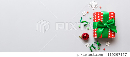 Top view Flat lay Christmas decorations and gift box on colored background with copy space. Christmas or Happy New Year composition 119297157