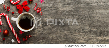 Delicious fresh festive morning coffee in a ceramic cup with little wrapped gifts, ornament and xmas toy. Cup of coffee and new year toys Delicious fresh festive morning coffee in a ceramic cup with little wrapped gifts, ornament and xmas toy. Cup of coffee and new year toys 119297204