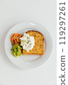 A beautifully arranged white plate, generously topped with a delightful combination of toast, fresh guacamole, salmon and a dollop of whipped cream 119297261