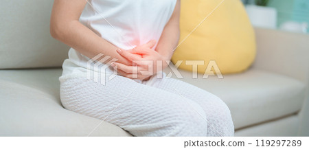 woman having abdomen ache due to Stomach pain, digestion with constipation or Diarrhea from food poisoning, female problem and Endometriosis, Hysterectomy, Stomachache and Menstrual on sofa at home woman having abdomen ache due to Stomach pain, digestion with constipation or Diarrhea from food poisoning, female problem and Endometriosis, Hysterectomy, Stomachache and Menstrual on sofa at home 119297289