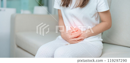 woman having abdomen ache due to Stomach pain, digestion with constipation or Diarrhea from food poisoning, female problem and Endometriosis, Hysterectomy, Stomachache and Menstrual on sofa at home 119297290