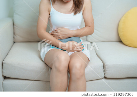 Menstruation period cycle of monthly and Stomachache concepts. woman having abdomen pain and menstrual ache with hot water bottle, illness female suffer from premenstrual ache and body Health problem 119297303
