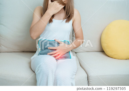 Menstruation period cycle of monthly and Stomachache concepts. woman having abdomen pain and menstrual ache with hot water bottle, illness female suffer from premenstrual ache and body Health problem 119297305