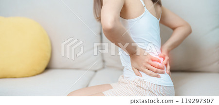 woman having back body ache during at home. adult female with muscle pain due to Piriformis Syndrome, Low Back Pain and Spinal Compression. Office syndrome and medical concept 119297307