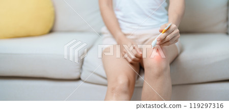 Arthritis and Muscle Pain Relief Cream concept. woman having knee ache and muscle pain due to Runners Knee or Patellofemoral Pain Syndrome, osteoarthritis, rheumatism and Patellar Tendinitis 119297316