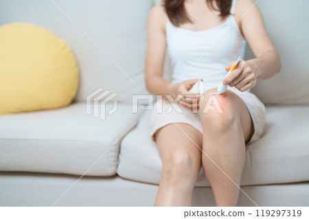 Arthritis and Muscle Pain Relief Cream concept. woman having knee ache and muscle pain due to Runners Knee or Patellofemoral Pain Syndrome, osteoarthritis, rheumatism and Patellar Tendinitis 119297319
