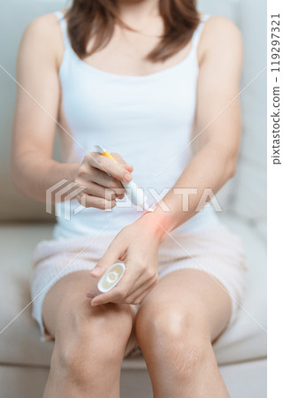 Arthritis and Muscle Pain Relief Cream concept. Woman having wrist pain at home, muscle ache due to De Quervain s tenosynovitis, ergonomic, Carpal Tunnel Syndrome or Office syndrome and Parkinson 119297321