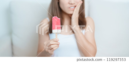 Teeth Sensitive to Cold concept. woman hold Ice cream and having toothache and pain after eat. Tooth Decay or Gum Disease, Grinding Teeth and Stress, Exposed Nerve Roots, Crack and Receding Gums 119297353