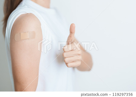 Woman with bandage after receiving vaccine. Vaccination and Immunization for Influenza, HPV, Zoster, IPD, DTP or Diphtheria, Tetanus and Pertussis, MMR, Hepatitis B, Covid  and Varicella vaccine 119297356
