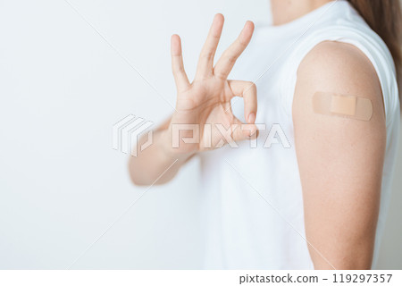Woman with bandage after receiving vaccine. Vaccination and Immunization for Influenza, HPV, Zoster, IPD, DTP or Diphtheria, Tetanus and Pertussis, MMR, Hepatitis B, Covid and Varicella vaccine Woman with bandage after receiving vaccine. Vaccination and Immunization for Influenza, HPV, Zoster, IPD, DTP or Diphtheria, Tetanus and Pertussis, MMR, Hepatitis B, Covid and Varicella vaccine 119297357