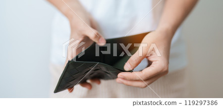 Woman hand holding and open empty wallet with not have banknote money. Crisis, loan, bankrupt and debt financial concept. Woman hand holding and open empty wallet with not have banknote money. Crisis, loan, bankrupt and debt financial concept. 119297386