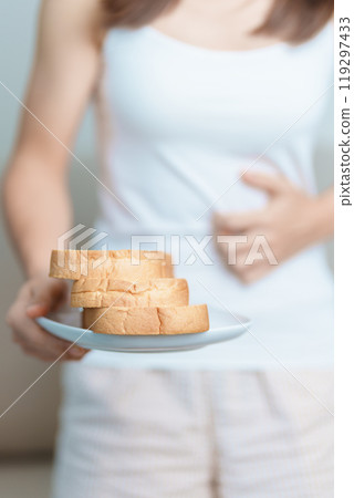 Gluten intolerance, Gluten free and celiac disease or wheat allergy concept. woman hold Bread and having abdominal pain after eat gluten. stomach ache, Nausea, Bloating, Gas, Diarrhea and Skin rash 119297433