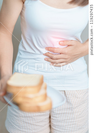 Gluten intolerance, Gluten free and celiac disease or wheat allergy concept. woman hold Bread and having abdominal pain after eat gluten. stomach ache, Nausea, Bloating, Gas, Diarrhea and Skin rash Gluten intolerance, Gluten free and celiac disease or wheat allergy concept. woman hold Bread and having abdominal pain after eat gluten. stomach ache, Nausea, Bloating, Gas, Diarrhea and Skin rash 119297435