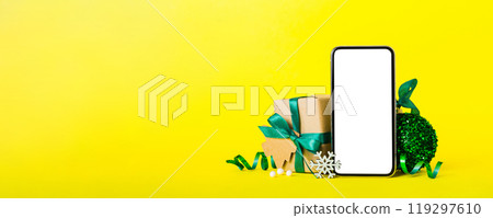 Digital phone mock up with rustic Christmas decorations for app presentation with empty space for you design. Christmas online shopping concept. Tablet with copy space on colored background 119297610