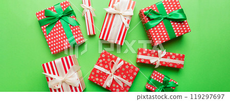 A lot of Christmas gift boxes in colored paper decorated on table, Top view close up. Many present New Year gift 119297697