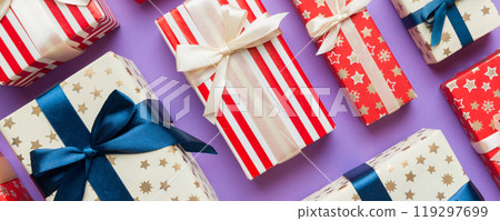 A lot of Christmas gift boxes in colored paper decorated on table, Top view close up. Many present New Year gift 119297699