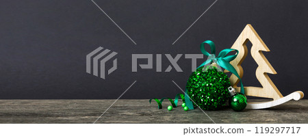Christmas ball with decorative wooden tree on colored background. decoration bauble with ribbon bow with copy space Christmas ball with decorative wooden tree on colored background. decoration bauble with ribbon bow with copy space 119297717