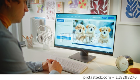 Young man enters prompt in AI image generator on PC 119298276