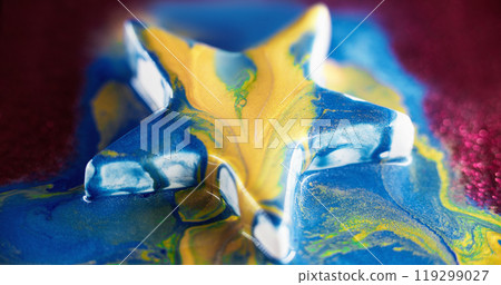 Paint star. Glitter liquid spill. Blue yellow color shimmering ink mix flow over abstract shape on blur pink bokeh light background. Paint star. Glitter liquid spill. Blue yellow color shimmering ink mix flow over abstract shape on blur pink bokeh light background. 119299027