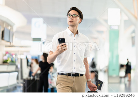 A man checking departure time at the airport A man checking departure time at the airport 119299246