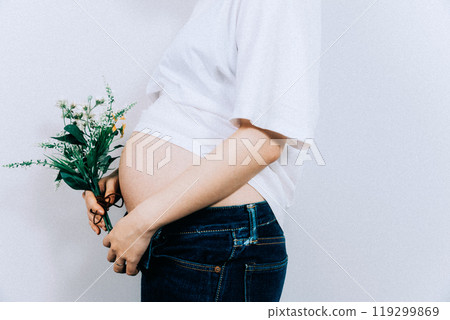 Pregnant woman taking maternity photos in studio 119299869