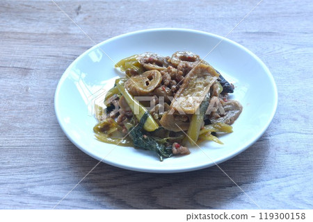 spicy stir fried gluten protein and tofu with basil dressing slice gree chili vegetarian fusion food on plate 119300158