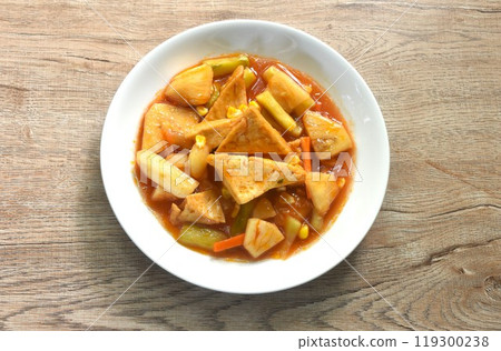 fried tofu with mixed vegetable in sweet and sour gravy sauce vegetarian food on plate  119300238