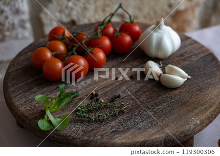 Cherry tomatoes on the marble cutting board  119300306