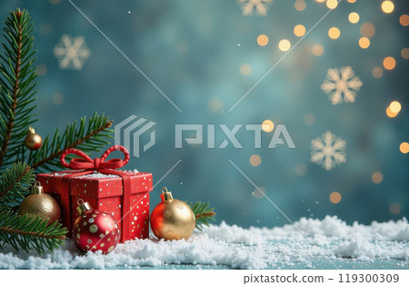 In the serene snow, a beautifully wrapped Christmas present rests quietly, with a festive Christmas tree standing majestically in the background 119300309