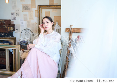 A woman surrounded by miscellaneous goods 119300362
