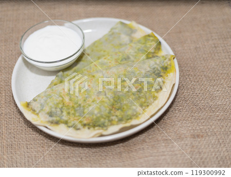 national cuisine, kutab with greens on a plate with kefir sauce national cuisine, kutab with greens on a plate with kefir sauce 119300992