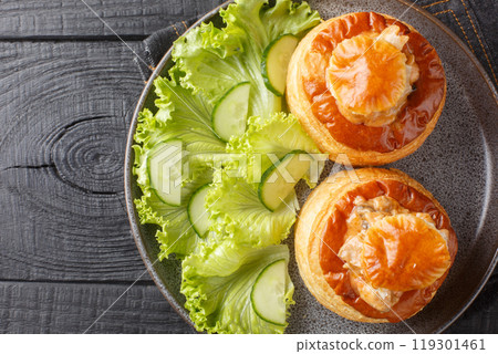 French appetizer bouchee stuffed with veal with mushroom sauce close-up in a plate. Horizontal top view 119301461