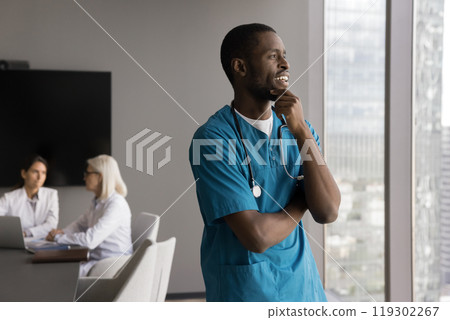 Young male doctor take break from conference look at window 119302267