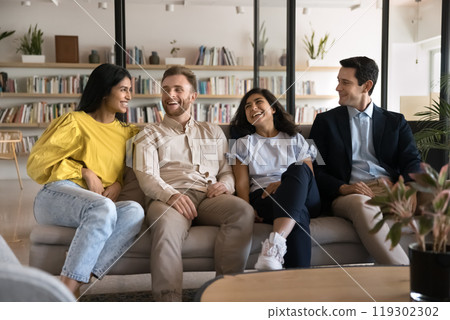 Multiethnic team of cheerful young adult students enjoying work break 119302302