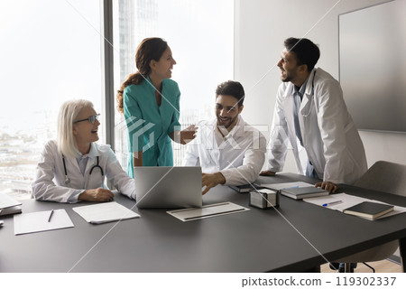 Laughing multiethnic physicians clinic employees having fun on team meeting 119302337