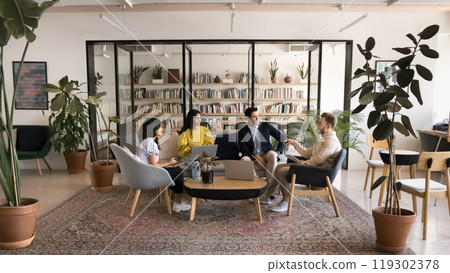 Diverse business team talking in modern co-working meeting space 119302378