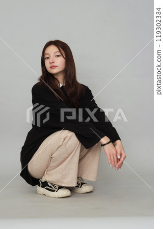 Young girl in a simple sweater, her pensive look capturing the introspective nature and challenges faced by today's youth. Young girl in a simple sweater, her pensive look capturing the introspective nature and challenges faced by today's youth. 119302384