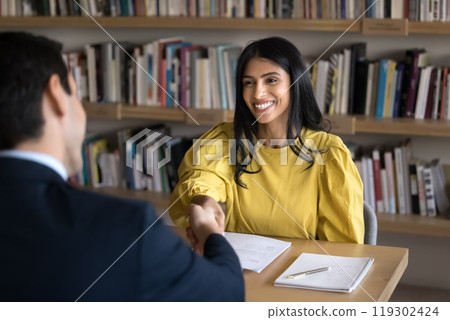 Cheerful Indian student woman talking to male professor in college Cheerful Indian student woman talking to male professor in college 119302424