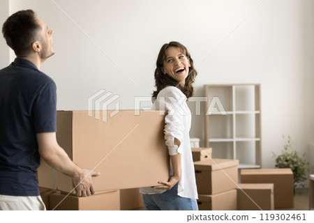 Laughing husband wife carry packages with stuff to new apartment 119302461