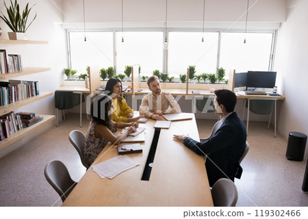 Serious engaged diverse business team talking in meeting room 119302466