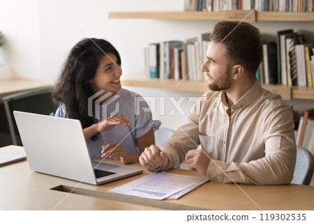 Happy multiethnic colleagues discussing startup marketing strategy 119302535