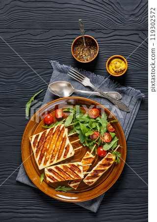 Grilled Greek Halloumi Cheese on sticks, top view 119302572