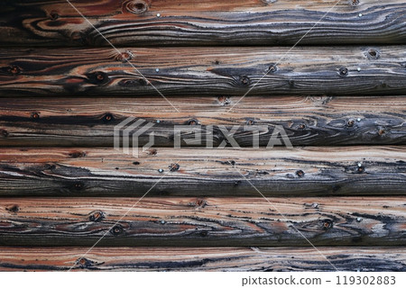 Background material of weathered gray logs from an old log house 119302883