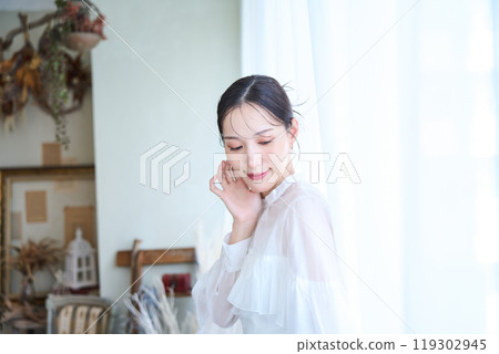 A woman surrounded by lace curtains A woman surrounded by lace curtains 119302945