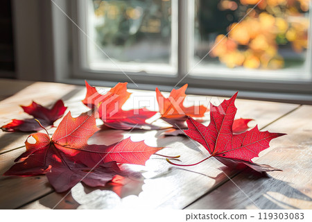 Autumn background scene with red maple leaves on table with sunlight. 119303083