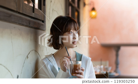 A woman drinking at a cafe 119303250